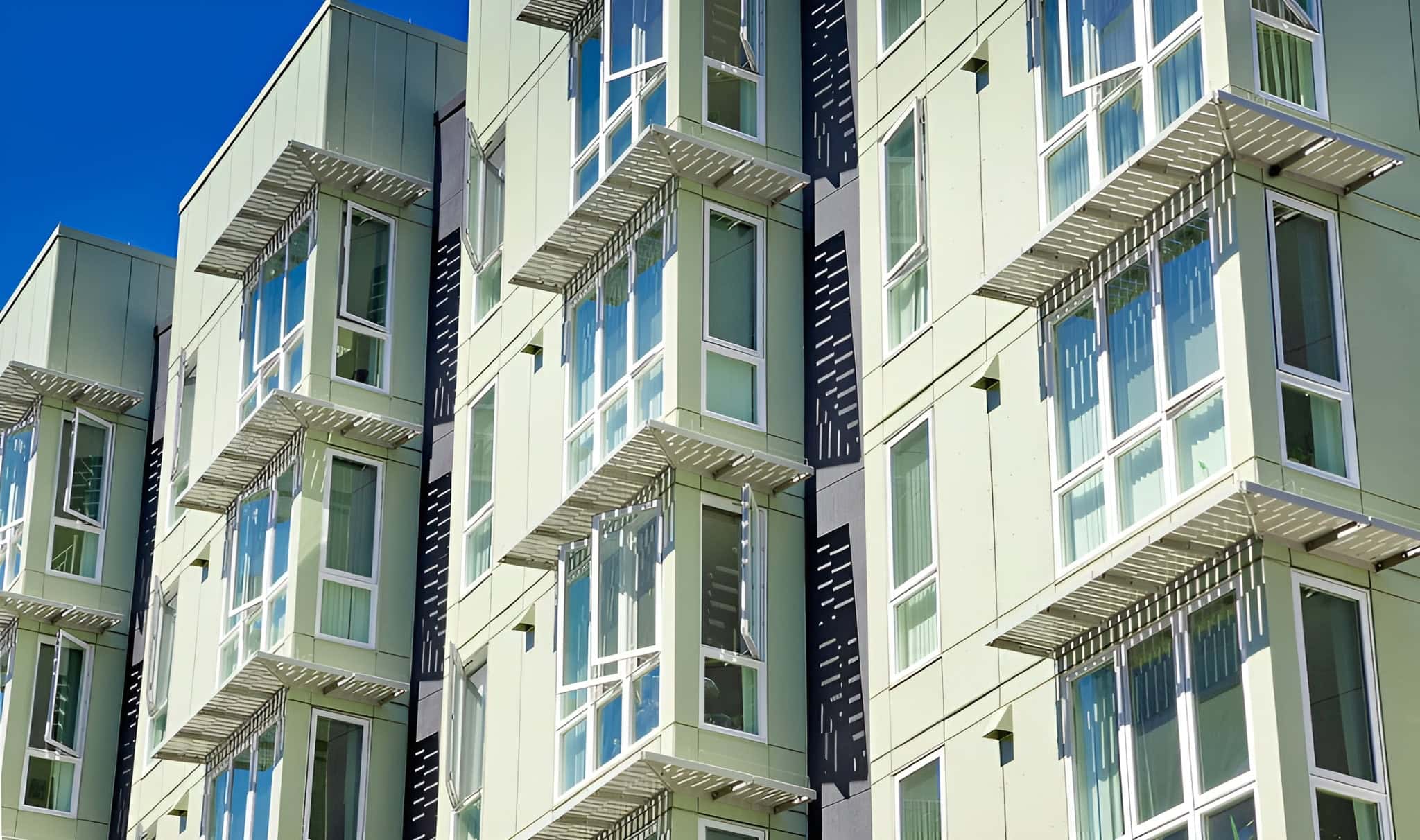 BOK Modern bracketed canopy covers on apartment exteriors