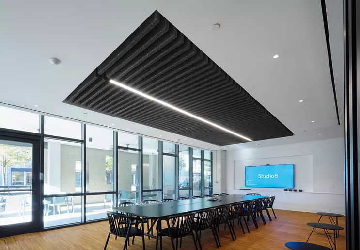 TECTUM Blades and Baffles installed in a custom color with light fixture attached for corporate meeting room